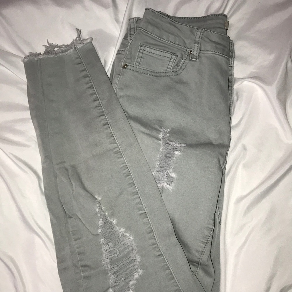 A pair of light green skinny jeans